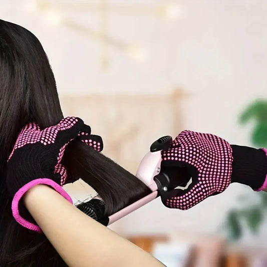 Heat-resistant glove with silicone bumps in use during hair styling, protecting hands from heat damage while handling hot tools.